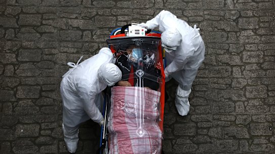 South Korean medical staff move a patient infected with the coronavirus from an ambulance to a hospital on March 09, 2020 in Seoul.