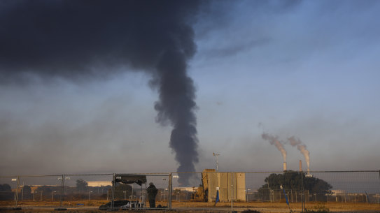 Smoke rises from an oil tank on fire after it was hit by a rocket  from Gaza, near the Israeli town of Ashkelon, Israel.