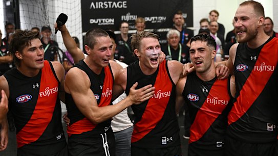 Sam Durham, Jake Kelly, Xavier Duursma, Jade Gresham and Ben McKay of the Bombers sing the song.