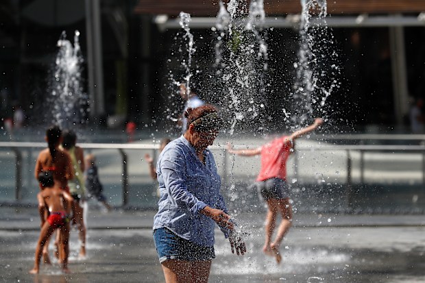 A woman refreshes at a fountain in Milan, Italy. Hot air from Africa is bringing a new heatwave to Europe, prompting health warnings (File image)