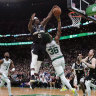 Jrue Holiday blocks a shot by Marcus Smart.