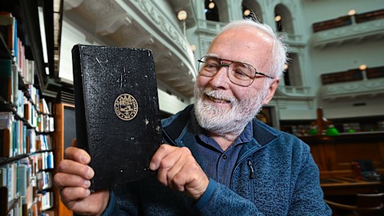 Graeme Coulson at the State Library of Victoria with the book on Malvern’s history that was 68 years overdue.