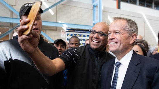 Labor leader Bill Shorten poses for a selfie during a marginal seat visit in Melbourne.