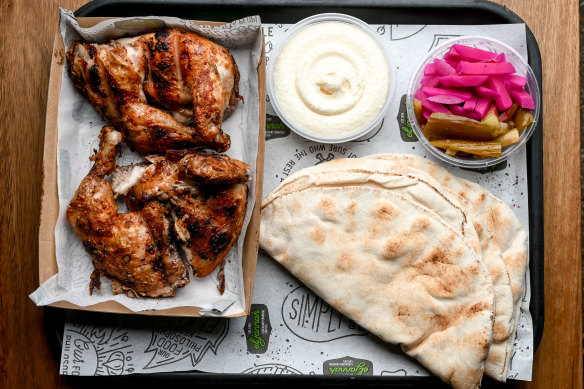 Whole chicken plate with pickles, pita and toum at El Jannah in Preston.