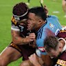 Tolutau Koula is tackled by Kalyn Ponga.