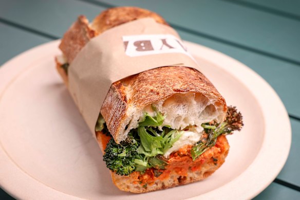 A sandwich filled with roasted broccolini, mozzarella, green olives and a capsicum and dried tomato pesto.