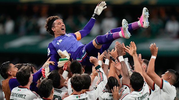 Mexico goalkeeper Guillermo Ochoa (13) is celebrated by his team.