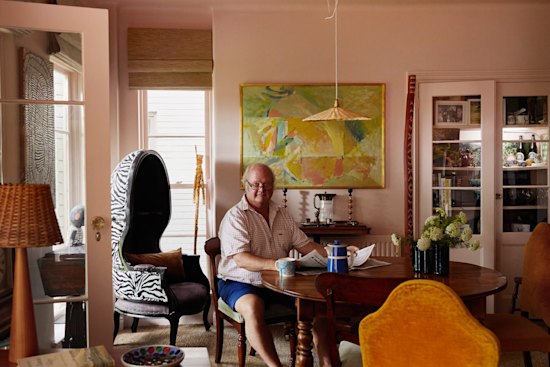 Peter Frith in his dining room, surrounded by eclectic objects. The willow pendant light is by Annemarie O’Sullivan of Studio Amos. The painting is by Alan Warren.