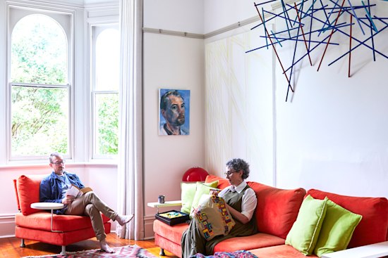 Chris Packer and Selina Samuels in the formal living room in the old part of their house, where vintage features are offset by modern furniture, light fittings and Packer’s contemporary artworks.