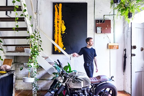 David Nakhla at the street entrance. A 1987 BMW motorcycle, his brother Andrew’s passion project, is an unorthodox centrepiece.