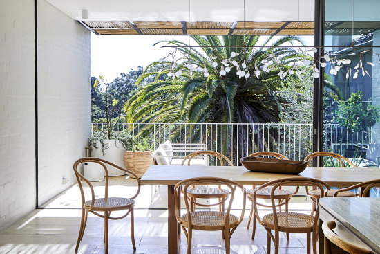 At the rear of the house, the open-plan entertaining zone flows from the airy dining area to a spacious outdoor terrace.