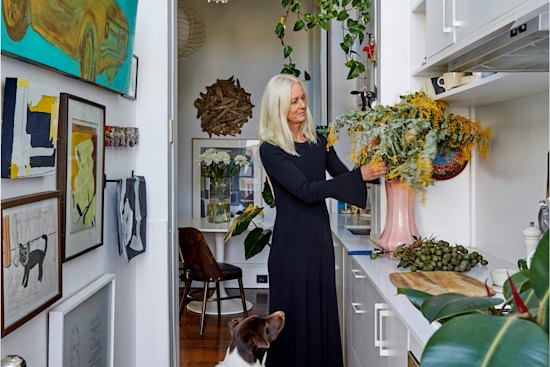 This space was once a light well and has been converted into a galley kitchen, recycling cabinets from the previous kitchen. Car painting by Robert Moore.
