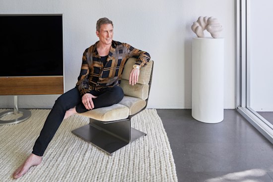 David Hicks seated on a 1970s Uginox lounge chair. The sculpture is by Narelle White and the copper glass disc is from eModerno.