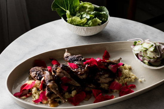 Quail with cous cous, rose petals and cucumber salad.
