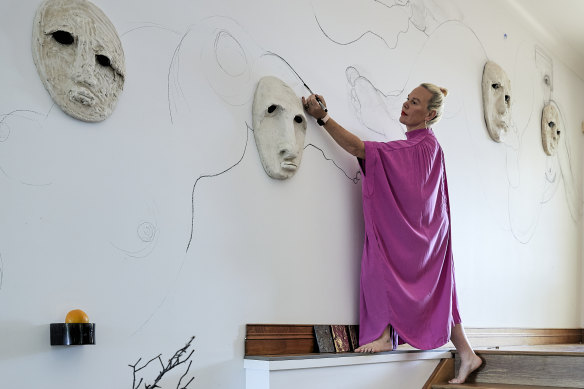 Sanné Mestrom and son Danté drawing in the wide entry hall. “I use every part of my home, inside and out, to make or display art,” Mestrom says.