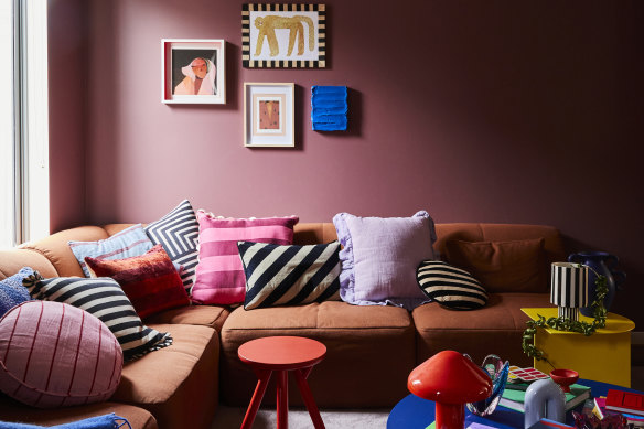 “We have regular movie nights and reconfigure the Eva sofa into a big bed so we can stretch out,” says Banfield. The wall colour is “Lampoon” by Dulux and the artwork at left is by Stacey Rees.