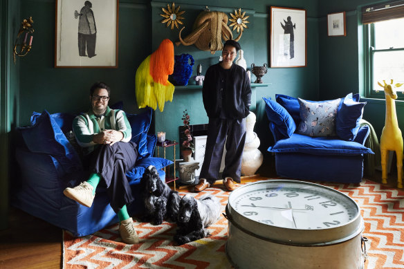 “Changing the walls from stark white to deep green created a moodier feeling in the space,” says Ben Elliott (left). The velvet chairs are by Molmic Furniture.