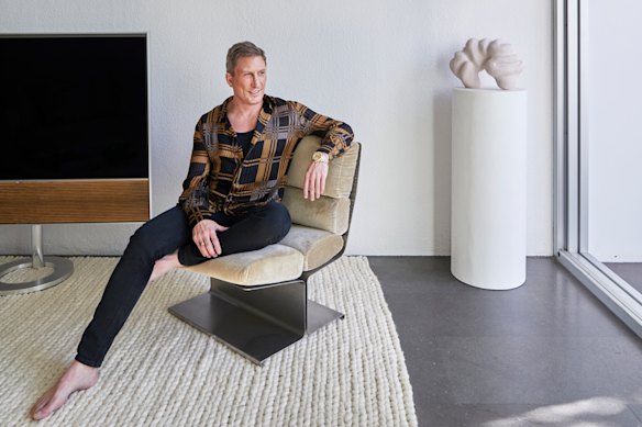 David Hicks seated on a 1970s Uginox lounge chair. The sculpture is by Narelle White and the copper glass disc is from eModerno.