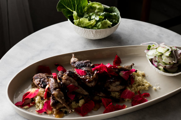 Quail with cous cous, rose petals and cucumber salad.