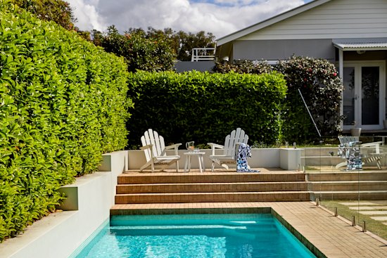 This blue-tiled heated pool with automatic in-floor cleaning looks after itself.
