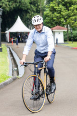 Prime Minister Anthony Albanese rides a bamboo bike around the Bogor Palace grounds.