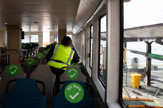 A Sydney ferry is cleaned while empty of passengers after another day of more locally transmitted cases of Covid-19.