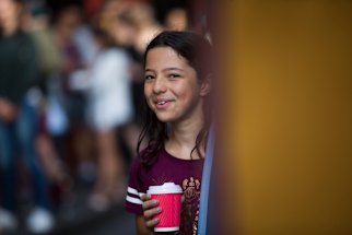 She's happy: Imani Butt, 9, texted her friends to tell them she had snared tickets to the dress rehearsal of the new Harry Potter play. 