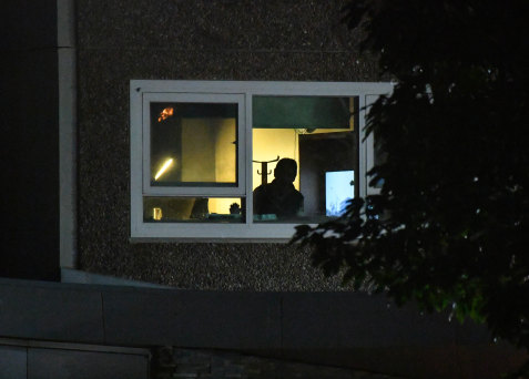 A resident inside the building subjected to Australia's harshest lockdown measures.