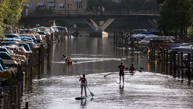 Paddle boards and canoes on Palsundet in central Stockholm last month.