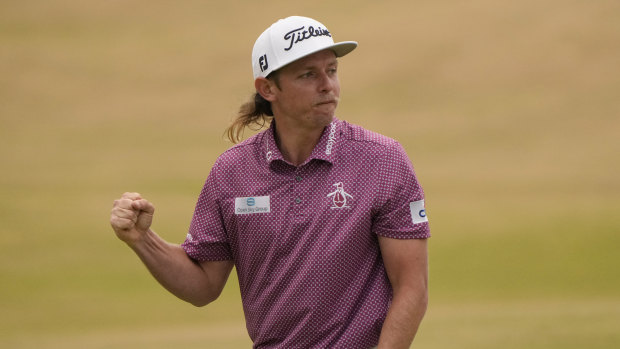 Cameron Smith celebrates on the 18th green after holing the winning birdie putt.