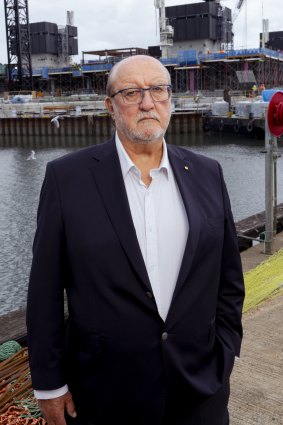 Former Sydney Fish Market chair Graham Turk at Blackwattle Bay, as the new building rises behind him.