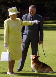 The late Queen Elizabeth II meets a corgi owner from the Adelaide Hills Kennel Club at Government House in Adelaide on February  28, 2002.