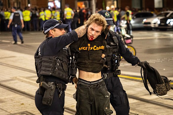 Protesters clashed with police near Town Hall on Monday night during Israeli President Isaac Herzog’s visit to Sydney.