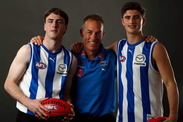 New North Melbourne players George Wardlaw and Harry Sheezel with coach Alastair Clarkson.
