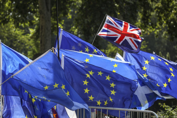 A British flag flies above European Union flags during a demonstration in London.