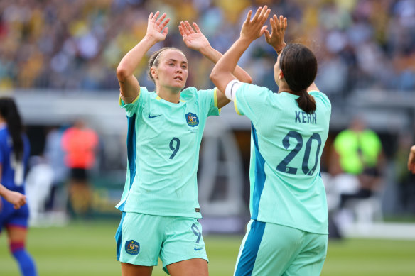 Caitlin Foord high fives Sam Kerr. The pair scored a hat-trick each against the Philippines on Sunday.