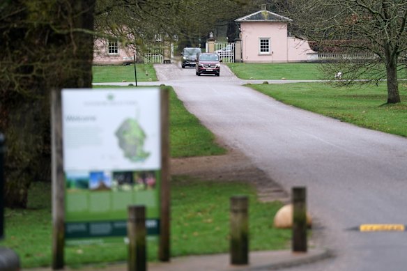 Cars move out of the Royal Lodge in Windsor.