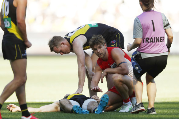 Sydney’s Dane Rampe shows concern for Kamdyn McIntosh after the pair collided in Saturday’s MCG match.