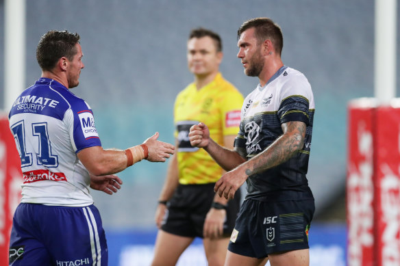 Bulldogs captain Josh Jackson goes to shake hands with Kyle Feldt but the Cowboys winger opts for a safer approach.