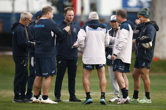 Brad Davis (left, with earpiece) is pictured in a Wallabies coaching huddle in Melbourne.