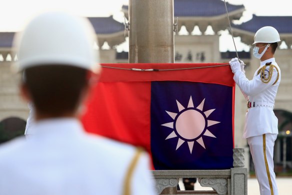 Taiwanese honor guards hold a Taiwan flag at Liberty Square, in Taipei, Taiwan. 