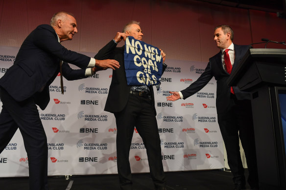Treasurer Jim Chalmers (right) has his address interrupted by a protester at the Queensland Media Club lunch.