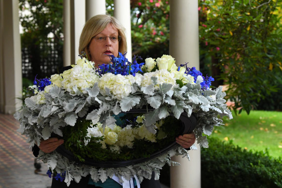Police Minister Lisa Neville with a wreath of flowers for Leading Senior Constable Lynette Taylor.