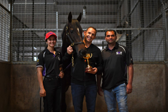 Chris Waller and staffers Marley Mezi and Rocky Mangat with Verry Elleegant and the Melbourne Cup on Friday.