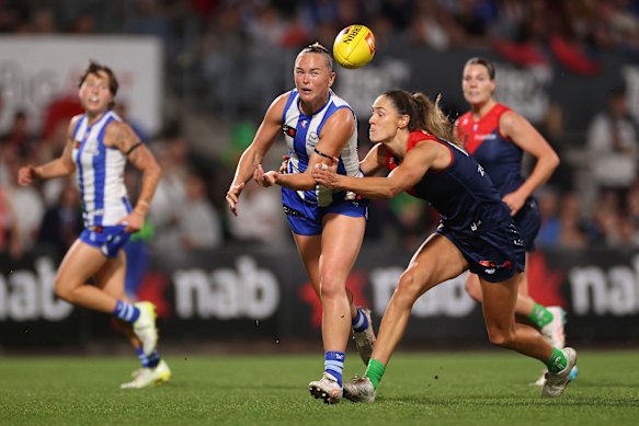 Vikki Wall of the Kangaroos handballs.