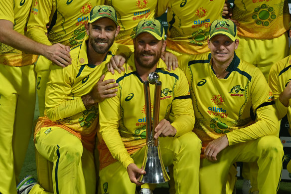 Glen Maxwell, captain Adam Finch and Steve Smith with the Chappell-Hadlee trophy in Cairns.