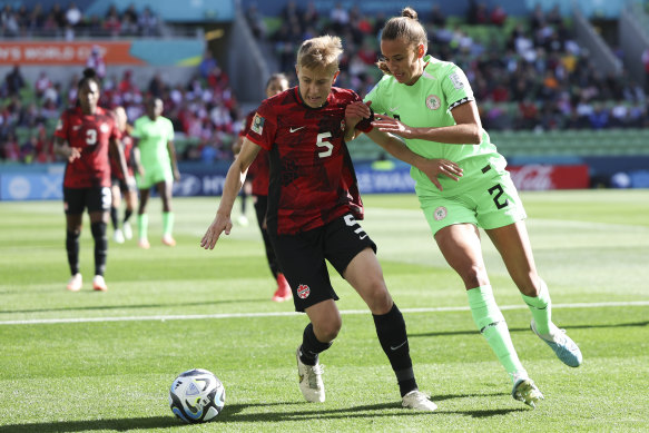 Canada’s Quinn and Nigeria’s Ashleigh Plumptre battle for the ball during their women’s World Cup Group B soccer clash.