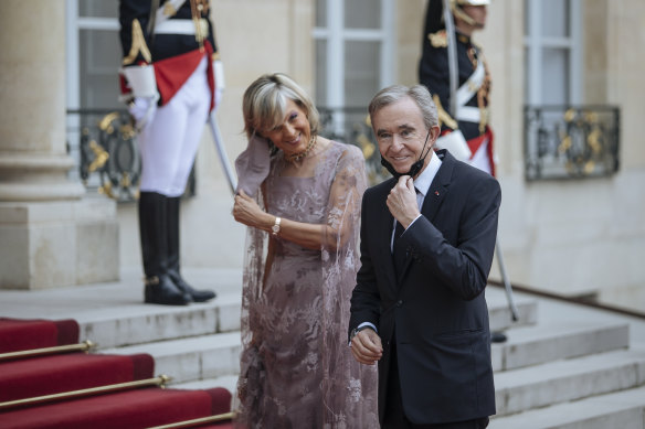 LVMH chief Bernard Arnault with wife Helene. The company is playing a pivotal role in the Olymnpics.