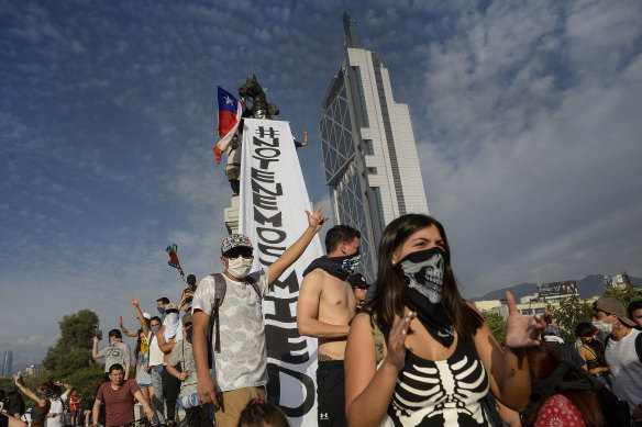 Chilean demonstrators shout slogans during the fifth day of protests against President Sebastian Piñera. 