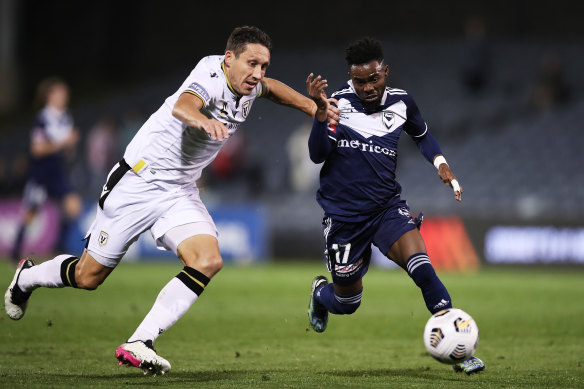 Elvis Kamsoba, who scored Victory’s goal, is challenged by Mark Milligan.